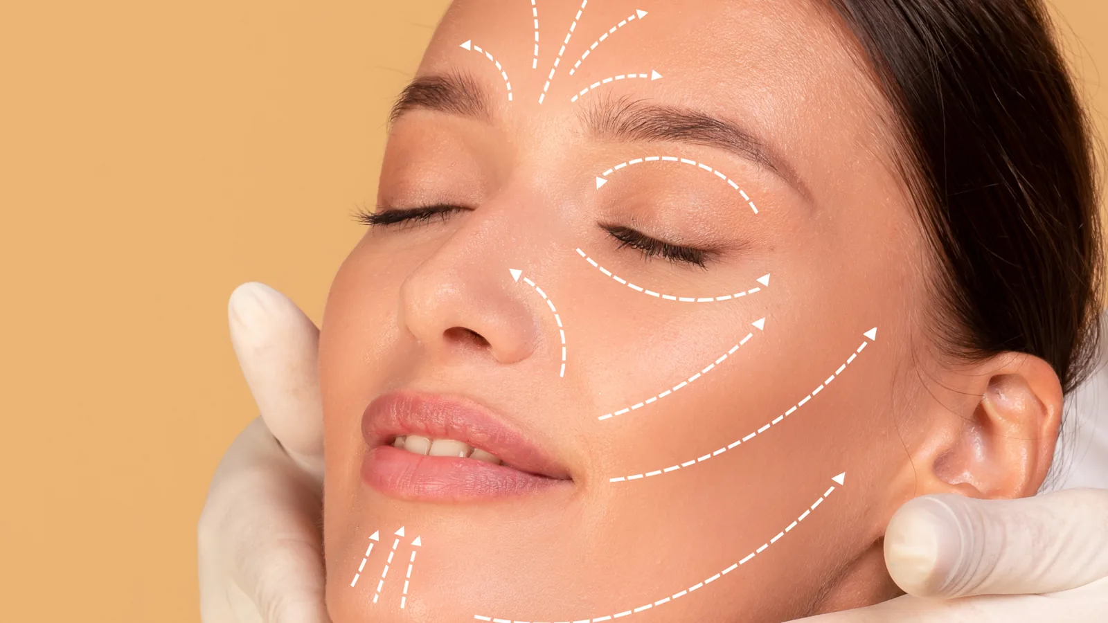 Woman with white guide lines drawn across her face during a consultation