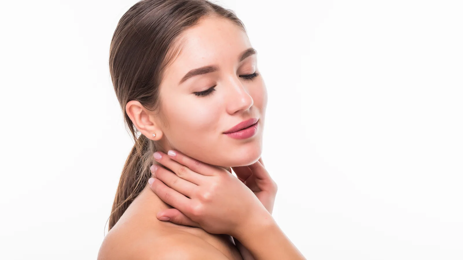 Woman with her eyes closed and one hand resting on her neck