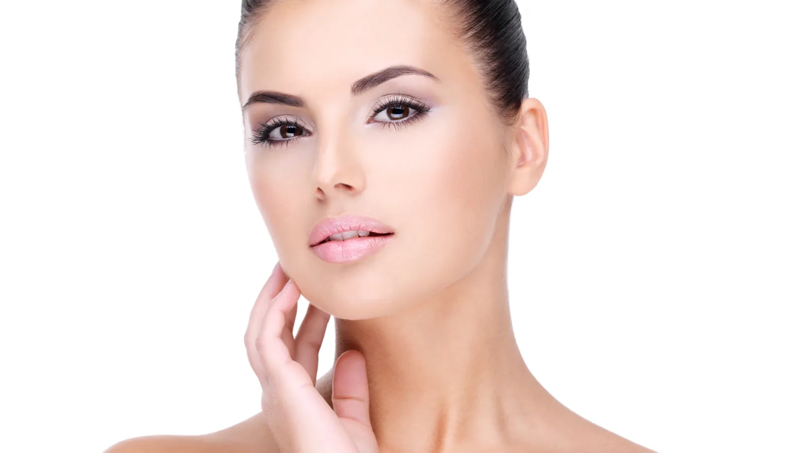 Woman with light makeup resting one hand on her neck